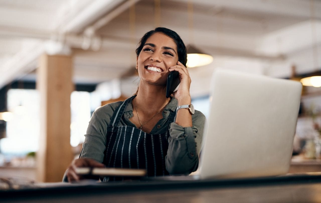 O que é o Certificado Digital e-CNPJ? | Foto de uma mulher empreendedora feliz em seu negócio | Certificação Digital | Blog da Certisign